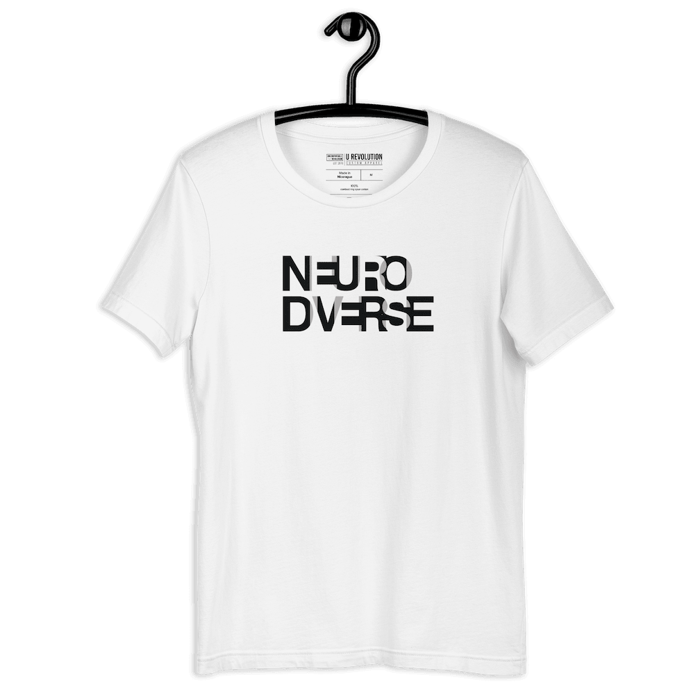 This is a white NeuroDiverse shirt that has the text NEURODIVERSE printed in large alternating black and white letters on the front, taking up about one-third of the shirt surface.  The shirt is displayed on a coat hanger.