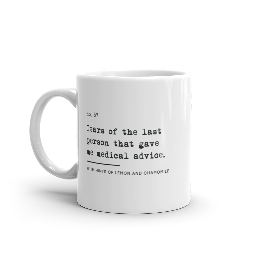 White ceramic mug with black text reading: “no. 57. Tears of the last person that gave me medical advice. With hints of lemon and chamomile.”