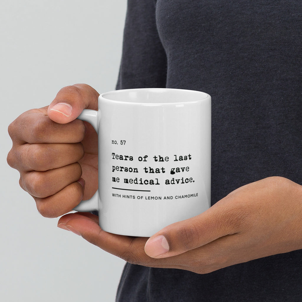 The no medical advice mug is white, with black text that reads: "no. 57. Tears of the last person that gave me medical advice. With hints of lemon and chamomile." 