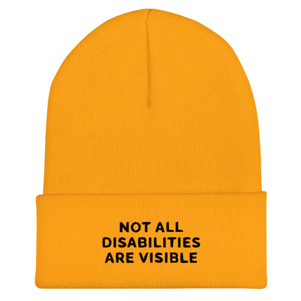 A gold Not All Disabilities Are Visible Beanie. The phrase, "Not All Disabilities Are Visible," is embroidered on the front of the beanie.