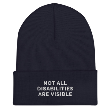 A navy Not All Disabilities Are Visible Beanie. The phrase, "Not All Disabilities Are Visible," is embroidered on the front of the beanie.