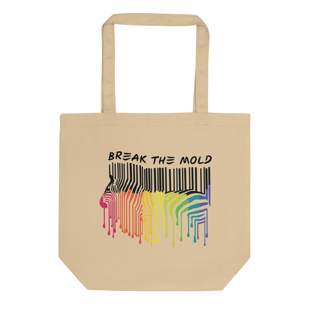 A photo of a natural organic break the mold tote bag. In the middle of the break the mold tote is a graphic of zebra in the silhouette of a barcode. The top half of the zebra are vertical black stripes, which then change just below the back into the colors of the rainbow. The bottom of each stripe has a paint drip mark. Just above the zebra's back is the phrase, in upper case, 'break the mold.'