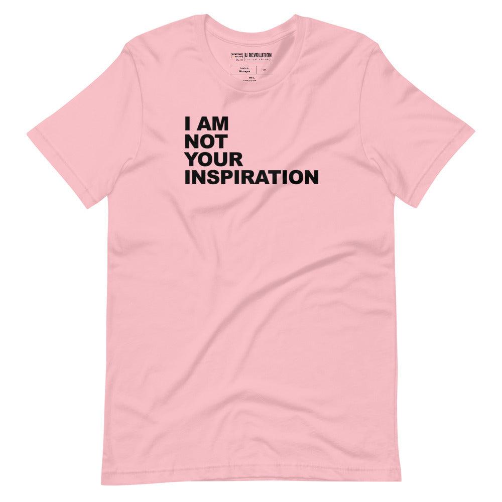 This is a pink 'I Am Not Your Inspiration" t-shirt. On the top third of the inspiration shirt is the phrase, "I am not your inspiration," printed over four lines in black upper case letters.