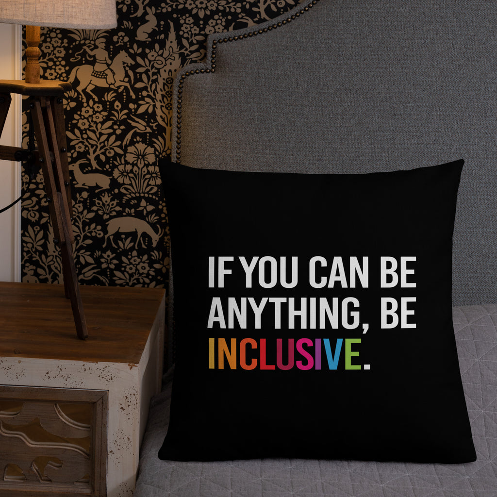 This is an image of a black premium Be Inclusive throw cushion. In the middle of the square throw cushion, the following phrase is printed in white upper case letters, "IF YOU CAN BE ANYTHING, BE INCLUSIVE." The word INCLUSIVE is in rainbow-like colors. 