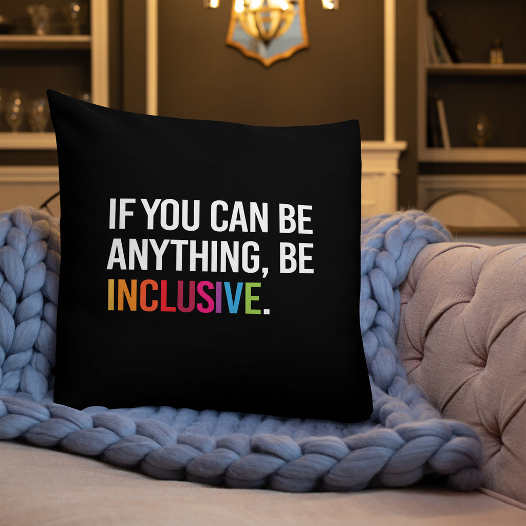This is an image of a black premium Be Inclusive throw cushion. In the middle of the square throw cushion, the following phrase is printed in white upper case letters, "IF YOU CAN BE ANYTHING, BE INCLUSIVE." The word INCLUSIVE is in rainbow-like colors. 