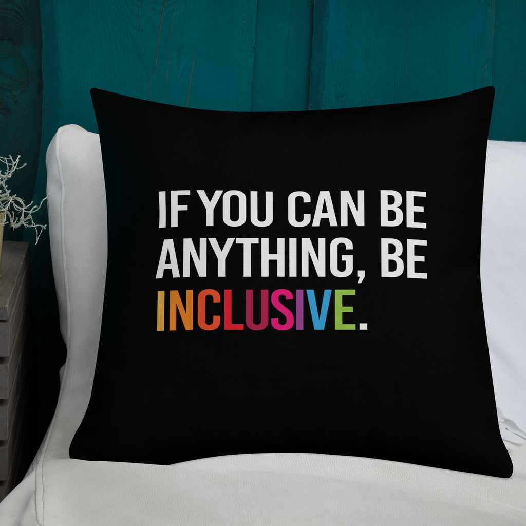 This is an image of a black premium Be Inclusive throw cushion. In the middle of the square throw cushion, the following phrase is printed in white upper case letters, "IF YOU CAN BE ANYTHING, BE INCLUSIVE." The word INCLUSIVE is in rainbow-like colors. 