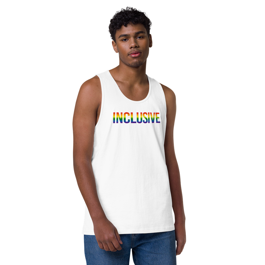 Photo of a white premium inclusive pride tank top. In the middle top 1/3 of the tank top is the word "Inclusive." The word is written in blended upper case rainbow pride colors:  red, orange, yellow, green, indigo, and violet.  The tank top is worn by a muscular model wearing blue jeans.