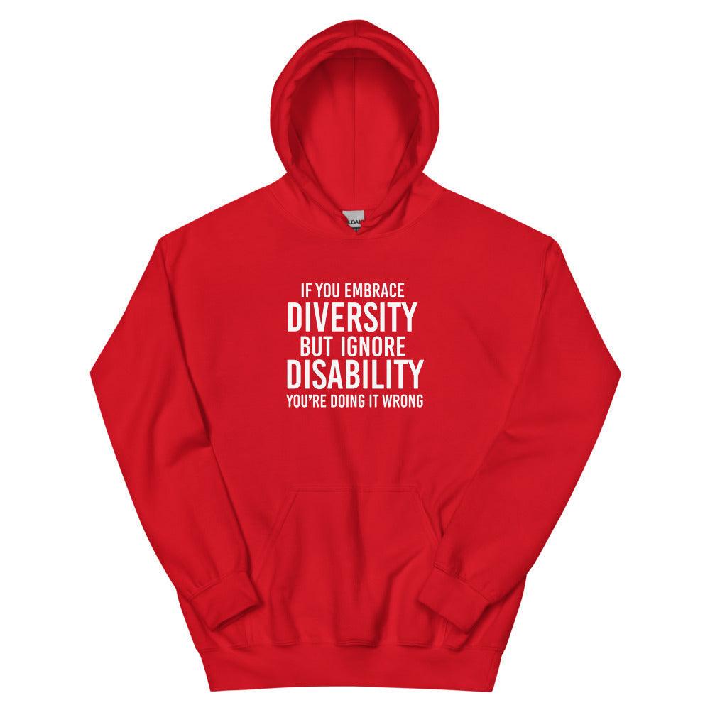 This is a photo of a red heavy blend embrace diversity hoodie with kangaroo pockets against a plain background. In the middle of the hoodie is a text graphic in bold upper case white letters. The text reads, "If you embrace diversity, but ignore disability, you're doing it wrong."