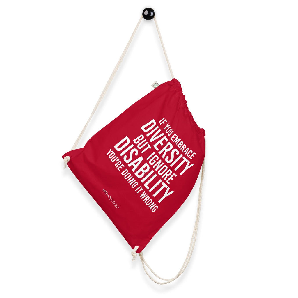 A red Embrace Diversity organic cotton drawstring bag. The middle of the drawstring bag features the phrase, printed in large white upper case letters, "If you embrace diversity but ignore disability, you're doing it wrong." The phrase fills 80% of the bag. 