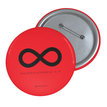 A photo of URevolution's round  neurodivergent pin badge. The neurodivergent pin is red and features a black infinity symbol, the symbol of the neurodiversity movement. Under the symbol is the phrase, 'neurodivergent a__f.'