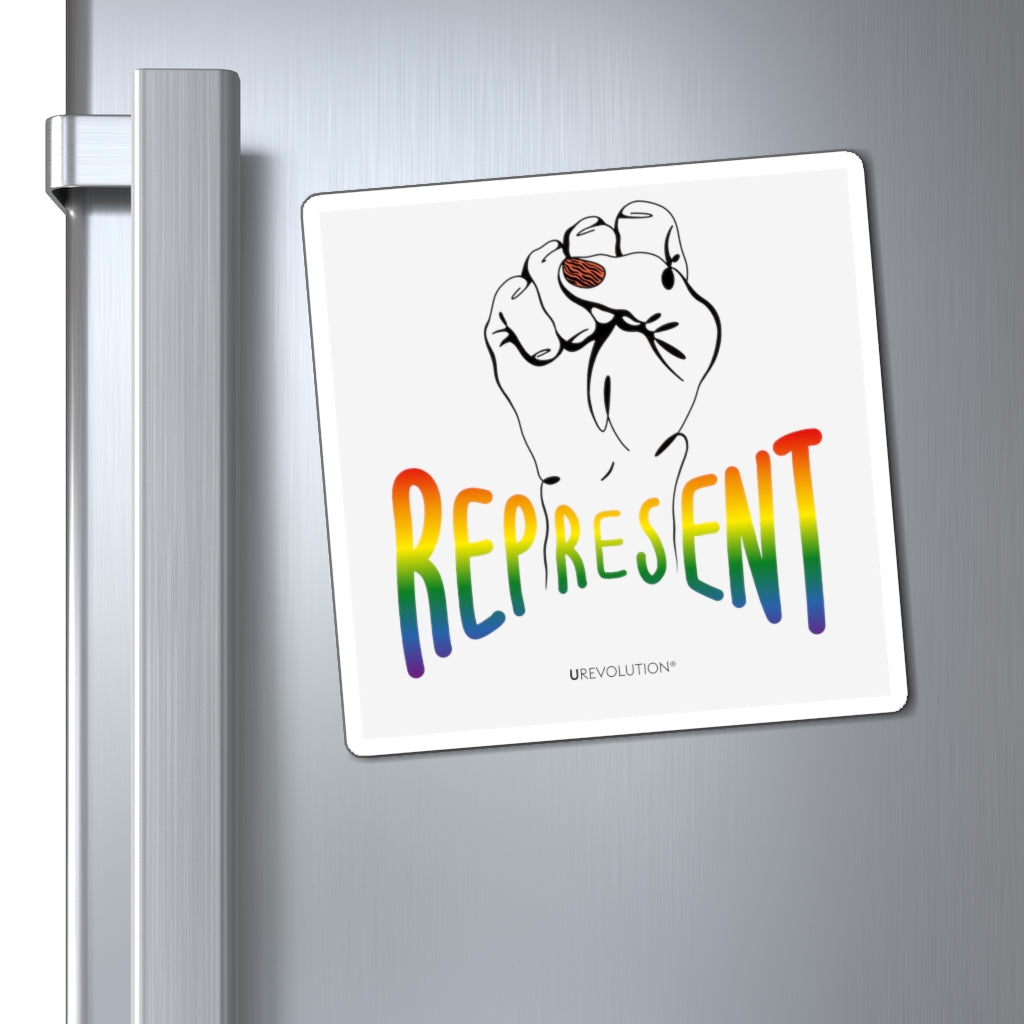 Photo of a square off-white Represent Pride Magnet. In the middle of the represent pride magnet is a black line drawing of a raised clenched fist, with the handwritten word "represent," written in blended upper case rainbow pride colors:  red, orange, yellow, green, indigo, and violet. Under the fist, at the bottom of the magnet, is the word URevolution in small black upper case letters. The pride magnet is displayed by itself on a stainless steel refrigerator door.
