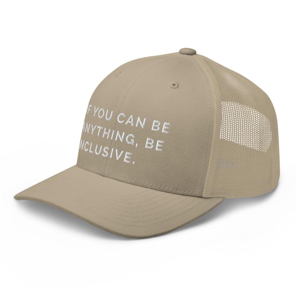 This is a photo of a khaki Be Anything Be Inclusive Trucker Cap. In the middle of the cap's front panel is the phrase, embroidered in white upper case letters, "If you can be anything, be inclusive." 