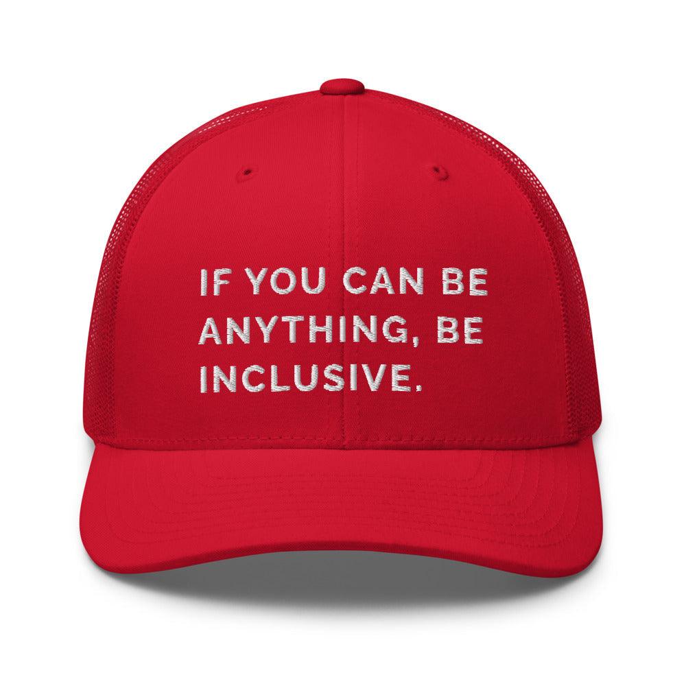 This is a photo of a red Be Anything Be Inclusive Trucker Cap. In the middle of the cap's front panel is the phrase, embroidered in white upper case letters, "If you can be anything, be inclusive." 