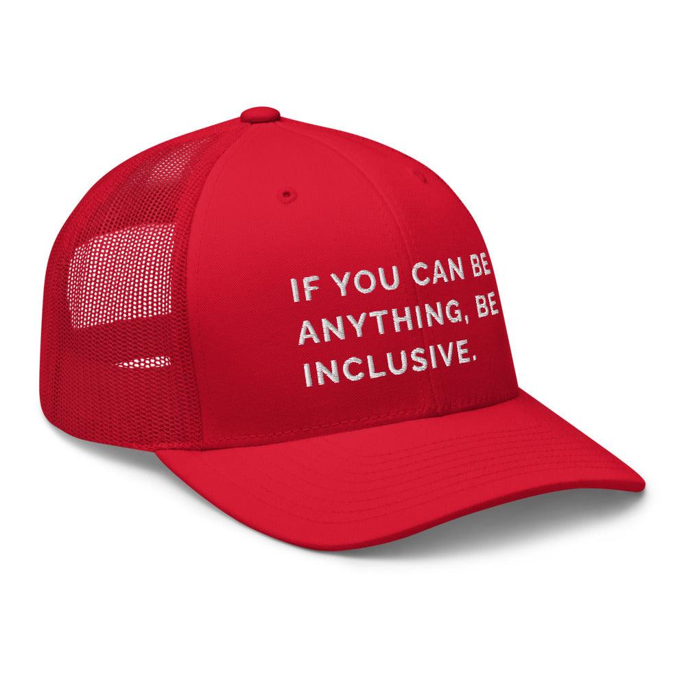 This is a photo of a red Be Anything Be Inclusive Trucker Cap. In the middle of the cap's front panel is the phrase, embroidered in white upper case letters, "If you can be anything, be inclusive." 