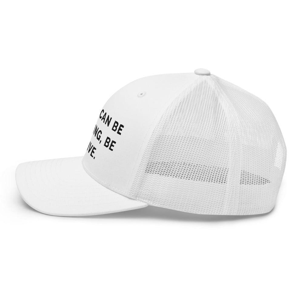 This is a side view of the mesh panels of a Be Anything Be Inclusive Trucker Cap. The cap visor is partially visible. 