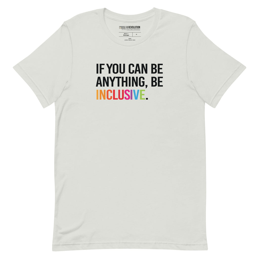 This is a photo of a silver rainbow classic Be Inclusive tee. On the front of the inclusive t-shirt is the phrase: "If you can be anything, be inclusive," in black upper case letters. All the text is in black, except "Inclusive," which is in rainbow colors.