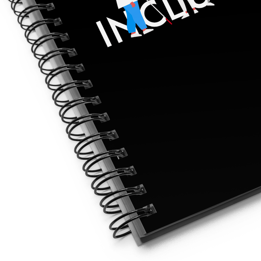 A close up of the inclusion notebook showing the black metal spiral binding.