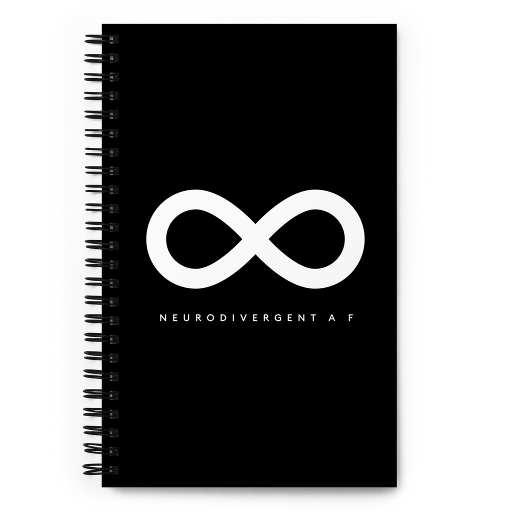 This is a photo of a spiral black Neurodivergent AF notebook. In the middle of the black notebook is an elegant black infinity symbol consisting of three thin black lines. Just below the infinity symbol is the word Neurodivergent AF in elegant upper case white letters. [Neurodivergent AF means Neurodivergent As Fuck]