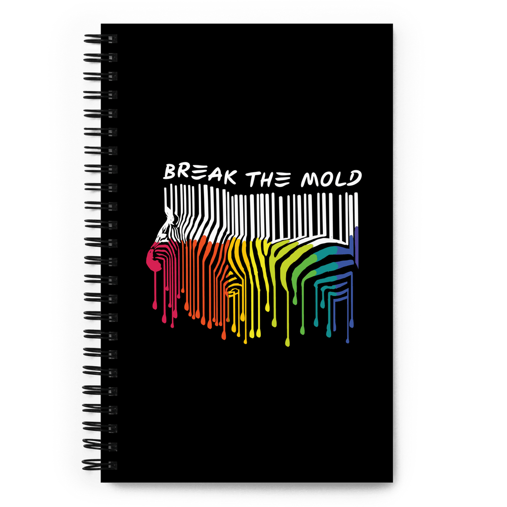 This is a photo of a black Break the Mold notebook. In the middle of the notebook cover is a graphic of zebra in the silhouette of a barcode. The top half of the zebra are vertical white stripes, which then change just below the back into the colors of the rainbow. The bottom of each stripe has a paint drip mark. Just above the zebra's back is the phrase, in upper case, 'break the mold.' the notebook has a black metal spiral binding.