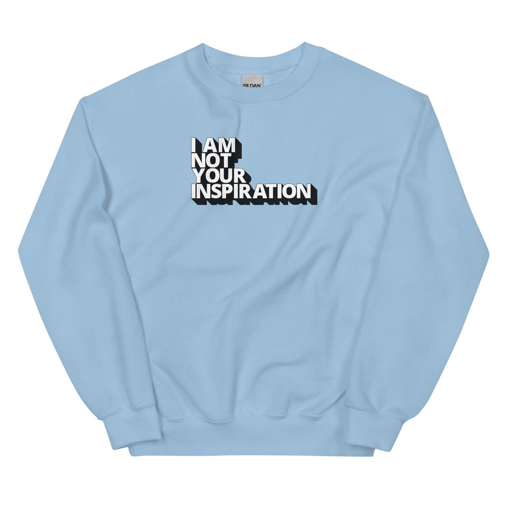 A light blue Not Your Inspiration sweatshirt. On the top third of the inspiration shirt is the phrase, "I am not your inspiration," printed over four lines in white upper case letters with a black retro shadow.