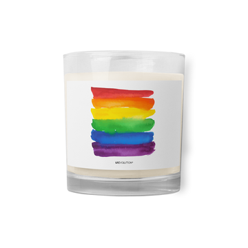 Photo of a Watercolor Rainbow Pride Flag Candle. On the front of the clear glass rainbow pride candle, on a white paper label, there is a large painted watercolor rainbow pride flag with the word URevolution underneath.