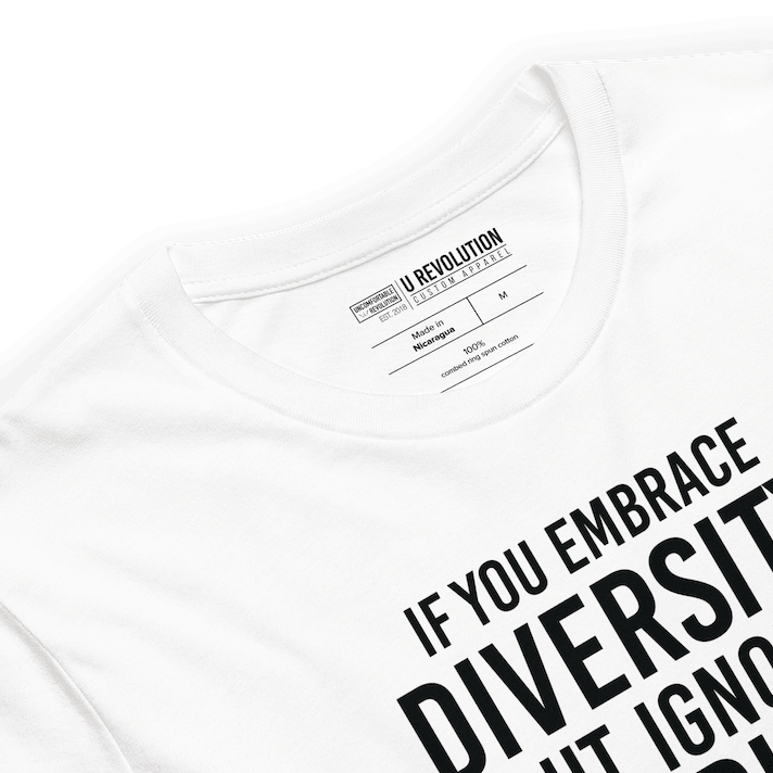 An image of a white Embrace Diversity T-Shirt. The t-shirt features the phrase, printed in white upper case letters, "If you embrace diversity but ignore disability, you're doing it wrong."