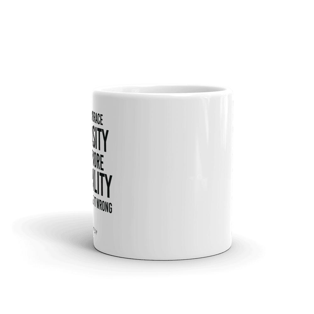 Photo of a white embrace diversity mug. The embrace diversity mug has a phrase printed in black in upper case letters: "If you embrace diversity but ignore disability, you're doing it wrong." The phrase takes up ¾ of the front side of the mug.