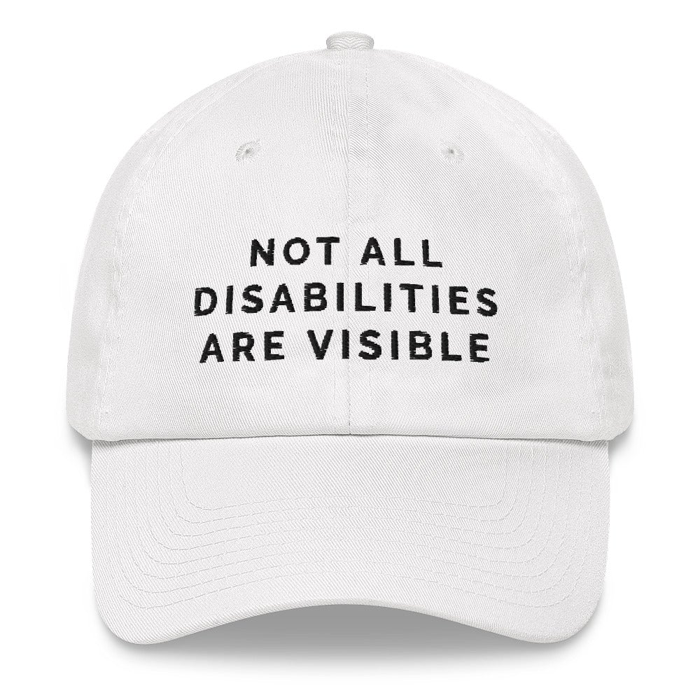 This is a photo of the front of a white Not All Disabilities Are Visible Cap. In the middle of the cap, in black embroidered upper case letters, is the phrase "Not All Disabilities Are Visible." The phrase is on three lines: (1) not all, (2) disabilities, (3) are visible.