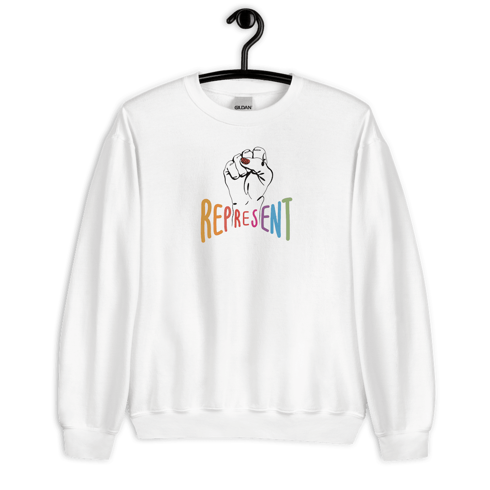 This is a photo of white represent sweatshirt. In the middle of the represent sweatshirt is a black line drawing of a raised clenched fist, with the handwritten word “represent,” written in upper case rainbow colors.