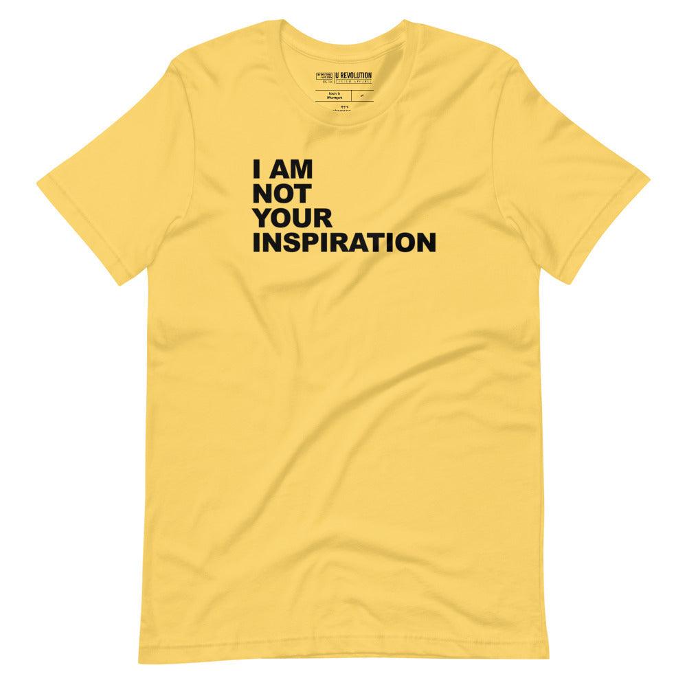 This is a yellow 'I Am Not Your Inspiration" t-shirt. On the top third of the inspiration shirt is the phrase, "I am not your inspiration," printed over four lines in black upper case letters.